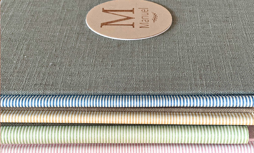 Detalle de portada de álbum de comunión en tela reciclada sostenible Colección Nativa.